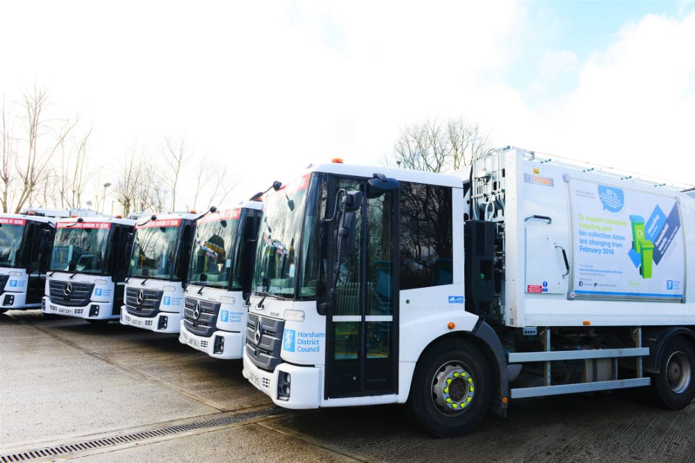 The waste and recycling trucks in a line