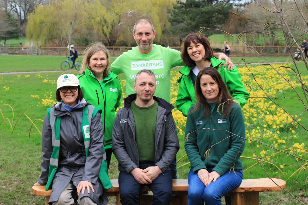Parks team, Samaritans and Friends of Horsham Park sit together on one of the reflection benches