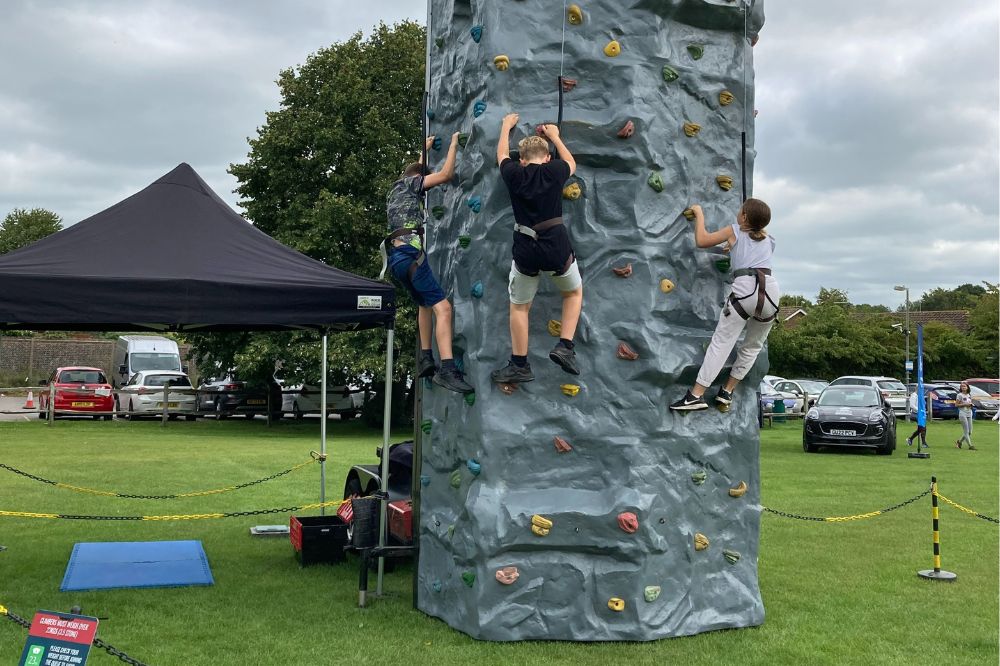 Children climbing a climbing wall
