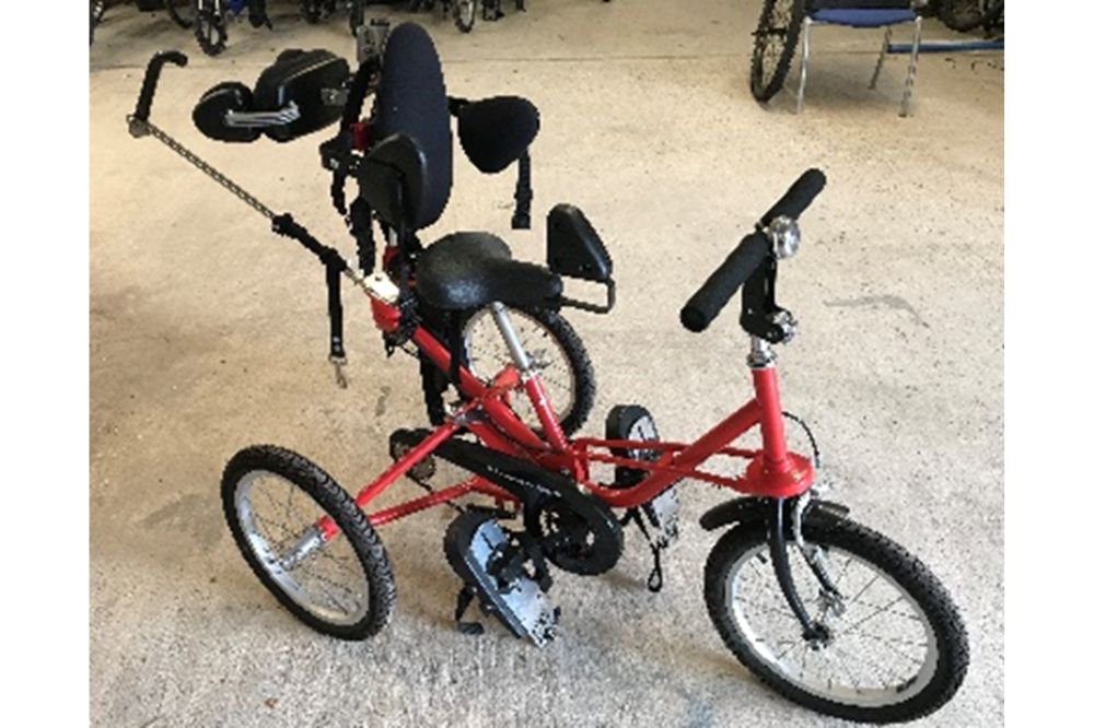 A red Tomcat 3-point trike with full seat and backrest