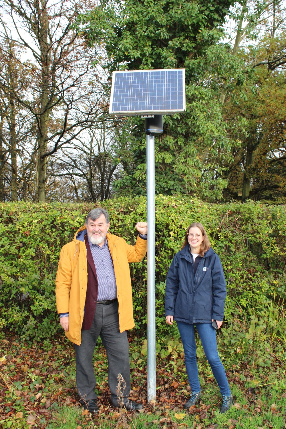 Horsham District Council Cabinet Member for Environmental Health, Recycling and Waste Cllr Jay Mercer and Environmental Protection Officer for Air Quality Thais Covre Delboni with the new air quality sensor in north Horsham