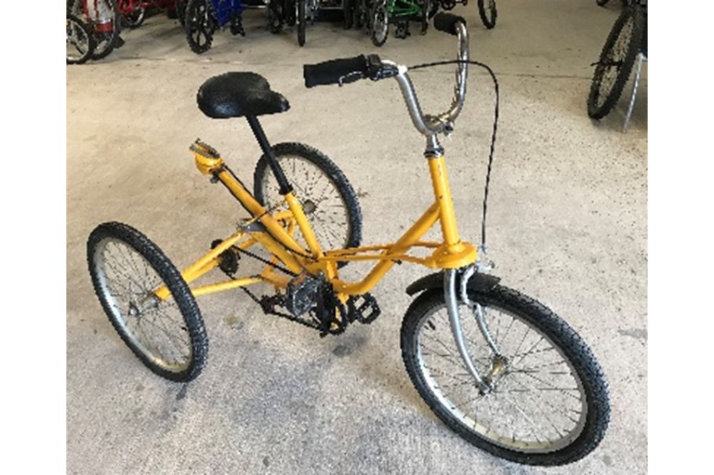 A yellow Tomcat trike with adjustable height saddle