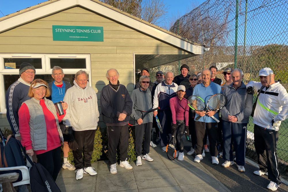 Steyning Tennis Club members huddle outside of the clubhouse on a spring morning