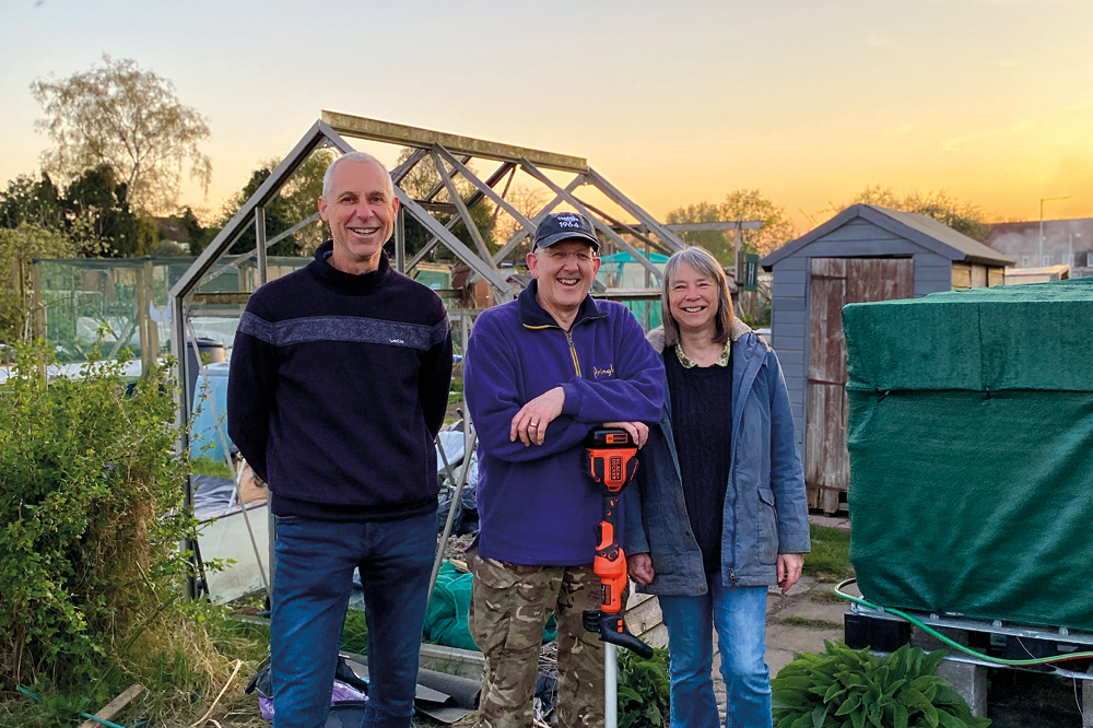Three members of the Lower Barn Allotment society with their rainwater harvesting station