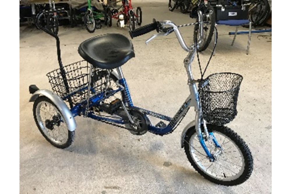 A silver trike with a shaped saddle for extra support and comfort