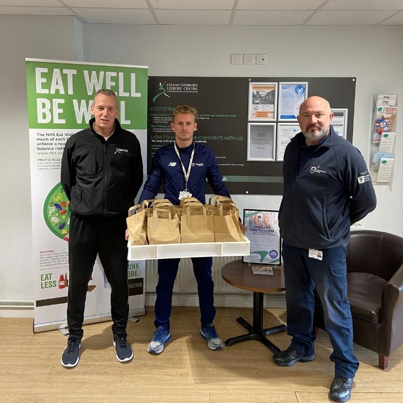 Storrington wardens and Premier Education with a tray of packed lunch bags for children