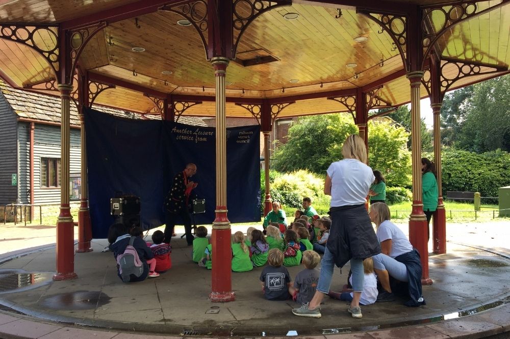 Steve Day performs a magic show for children on the Horsham Park Podium