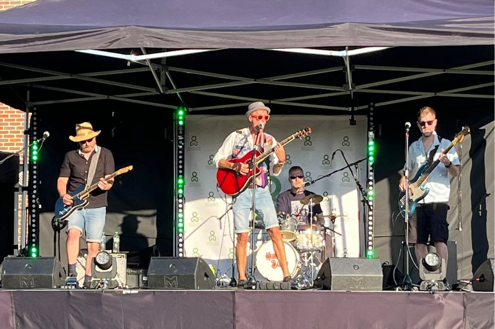 Hurly Burly perform on stage at Crawley Rugby Club