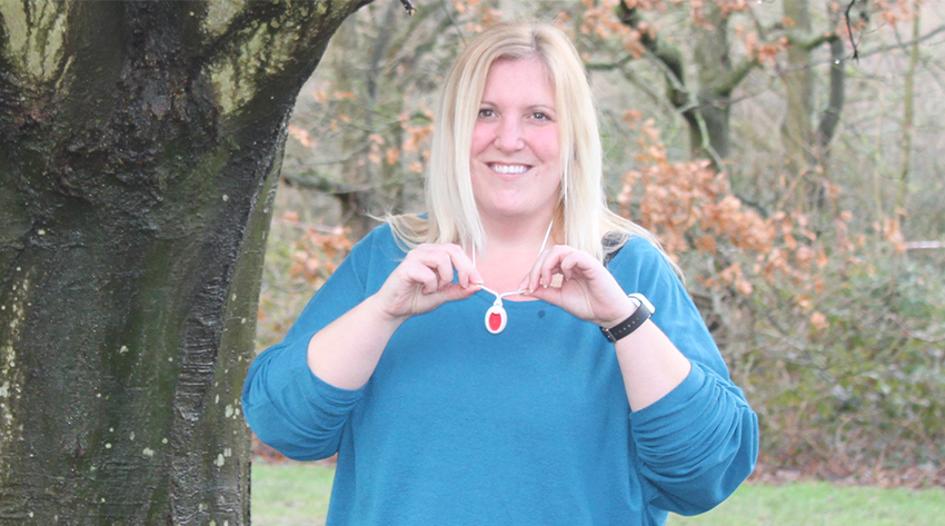 Sarah Dzwonnik, posing with her lifeline alarm