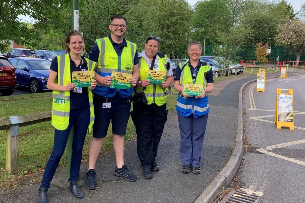 Council staff holding Walk to School Week leaflets