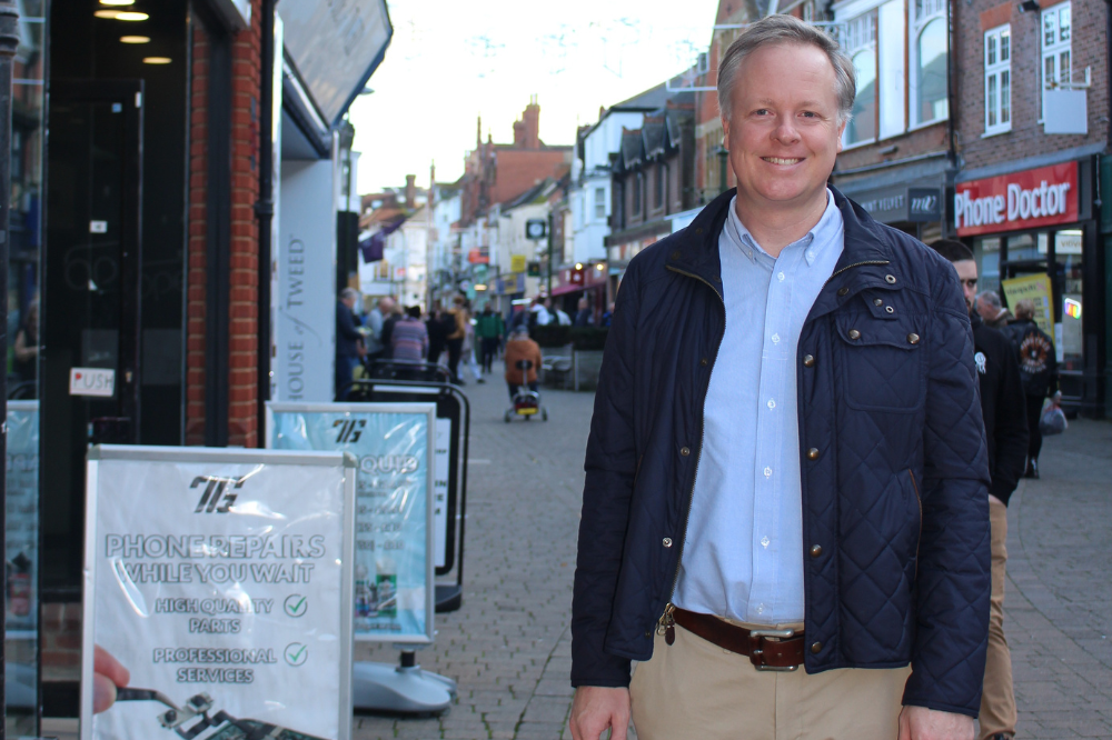 Cllr Christian Mitchell pictured next to a set of compliant advertising A-boards