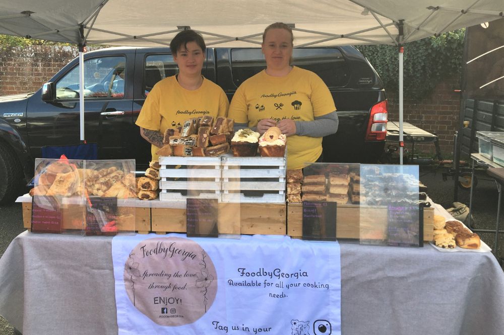 Two stallholders at their market stall