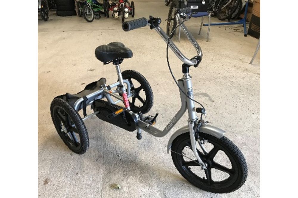 A silver trike with adjustable height saddle