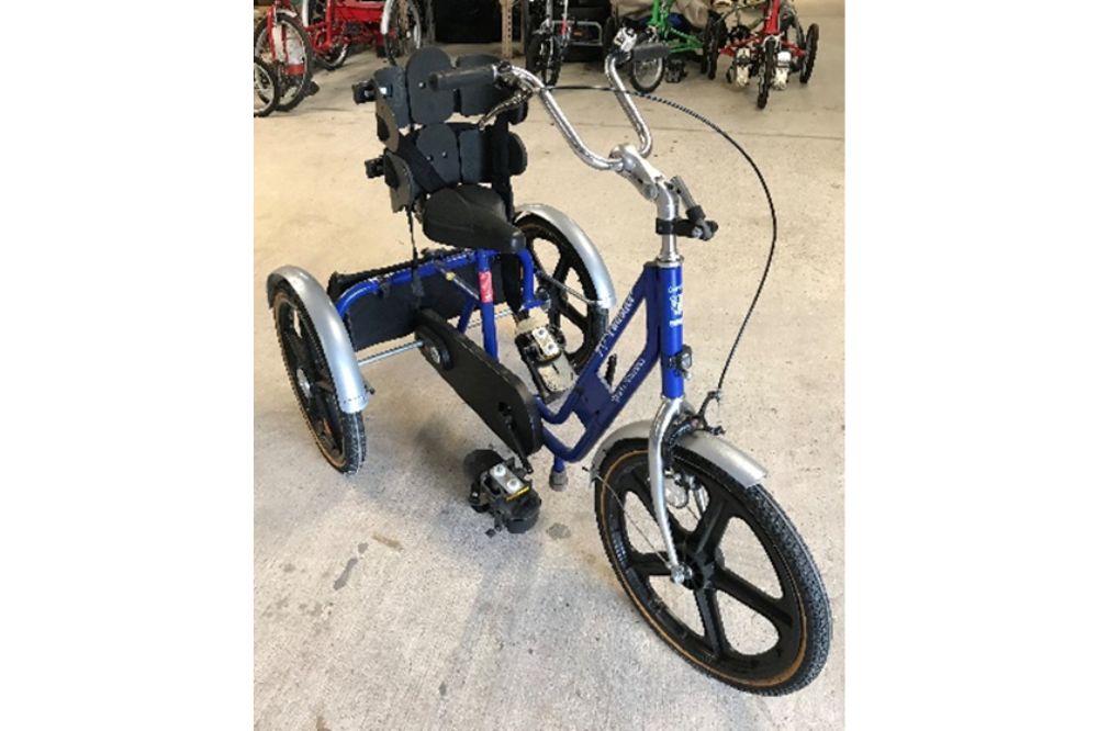 A blue trike with seat and harness