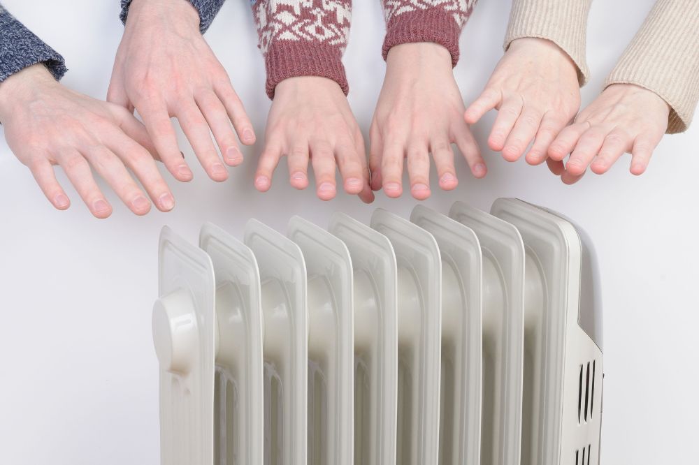 Hands on a radiator
