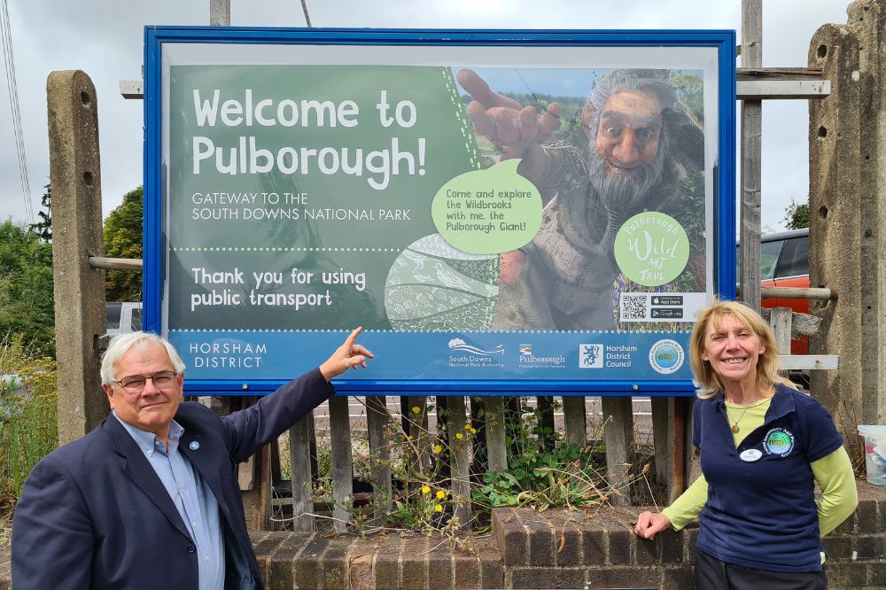 A sign on Station Approach reads Welcome to Pulborough and thanks visitors for using public transport