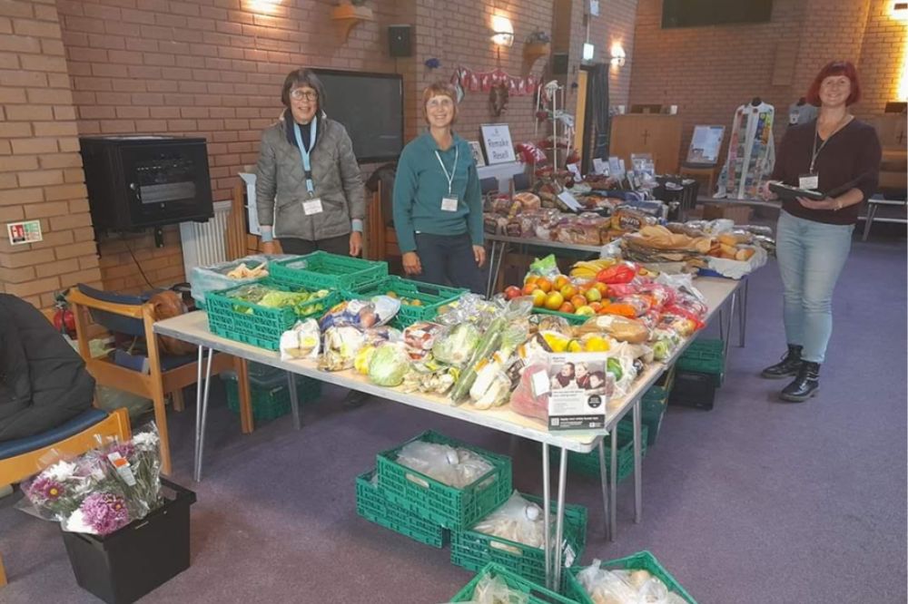 Volunteers gathered around a food stall at United Reform Church, Horsham