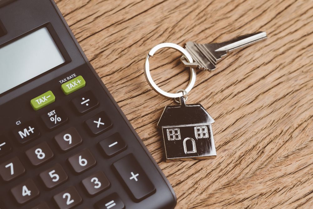 A set of house keys next to a calculator