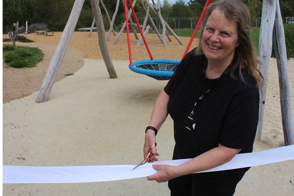 Cllr Ruth Fletcher cutting the ribbon opening the new play area.