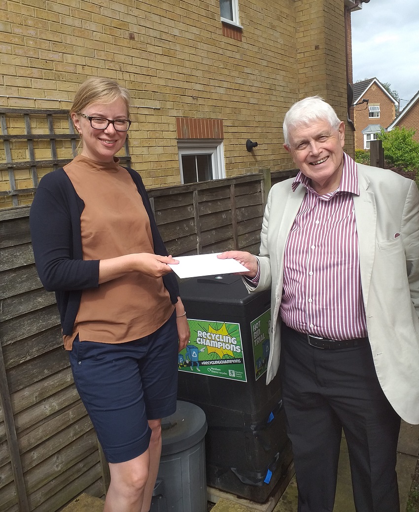 As a thank you for pioneering HDCs Hot Bin trial Cllr Philip Circus presents vouchers to Amanda Coakley