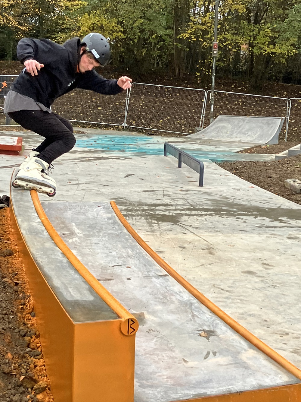 Inline skater on an orange track