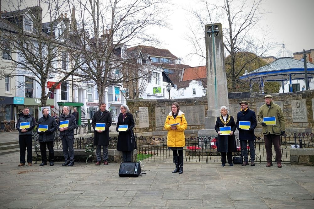 Holding Ukraine flags at the war memorial