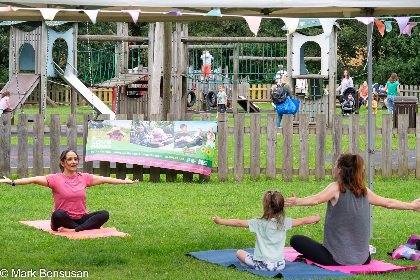 A group of children stretch in a park