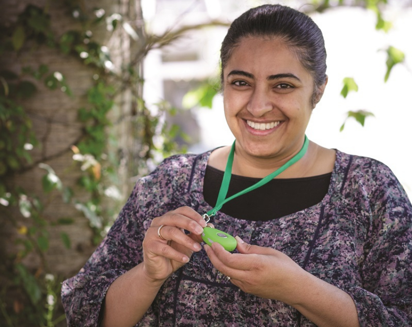 Lady holding green Footprint device