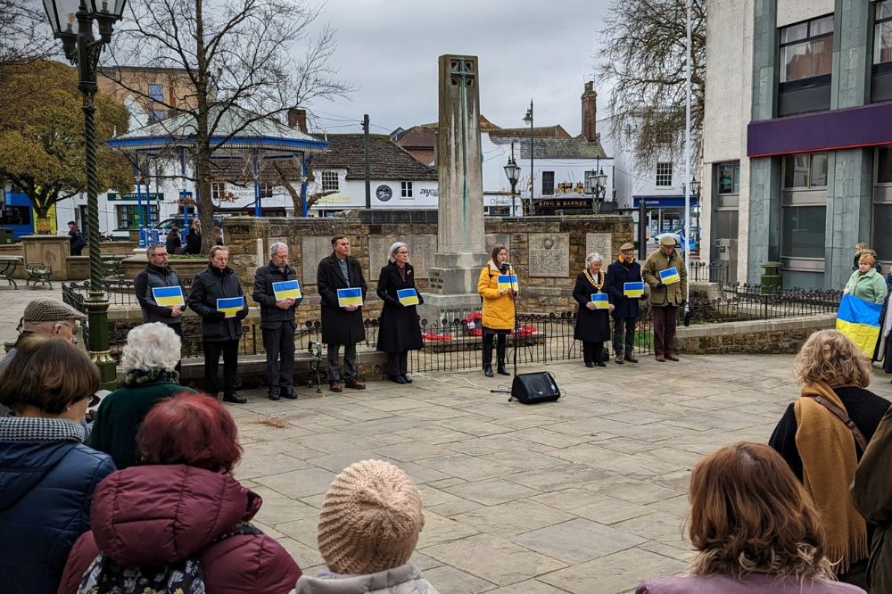Holding Ukraine flags at the war memorial
