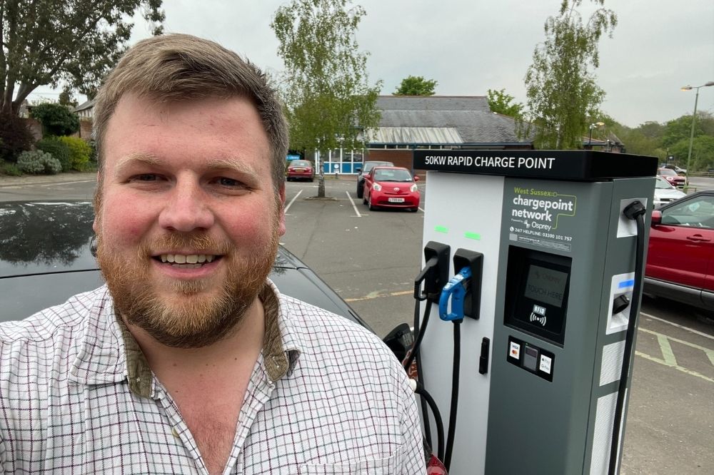 Cllr James Wright with new EV charge points in Storrington Library car park