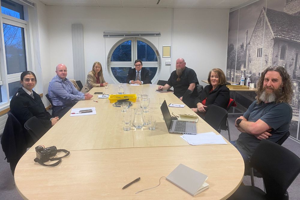 A spacious meeting room with representatives from Sussex Police, Horsham District Council, and Jeremy Quin MP