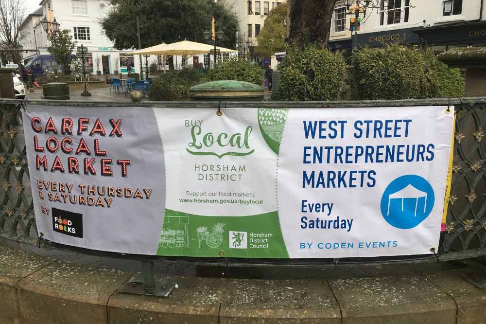 A banner with contact details for the three Horsham markets
