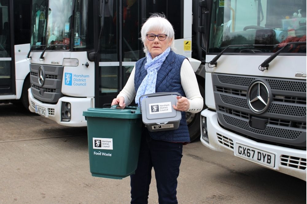 Cllr Toni Bradnum with a food waste caddy and bin