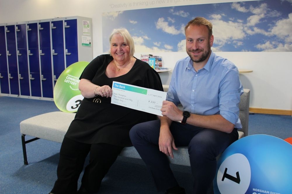 •	Horsham District Community Lottery winner Pam Thompson with HDC Head of Community Services Rob Jarvis 