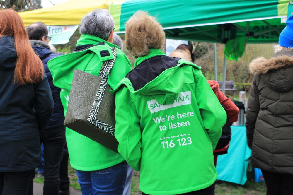 Volunteers for Samaritans in green coats