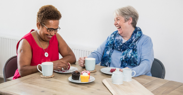 Ladies laughing with cake