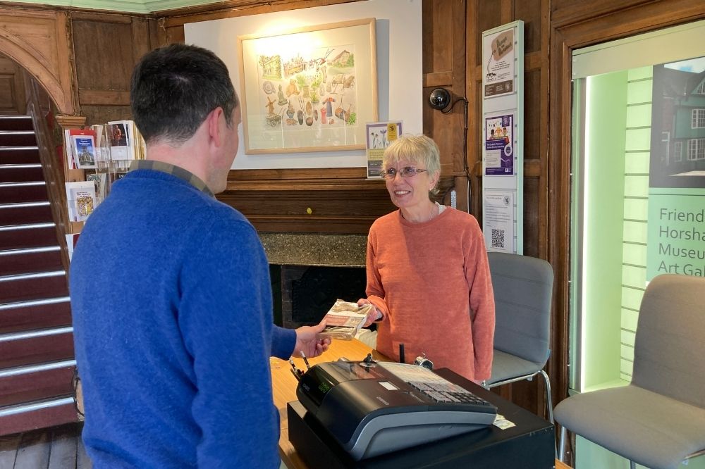 Volunteer Jackie Reeves selling Horsham Gingerbread to a visitor