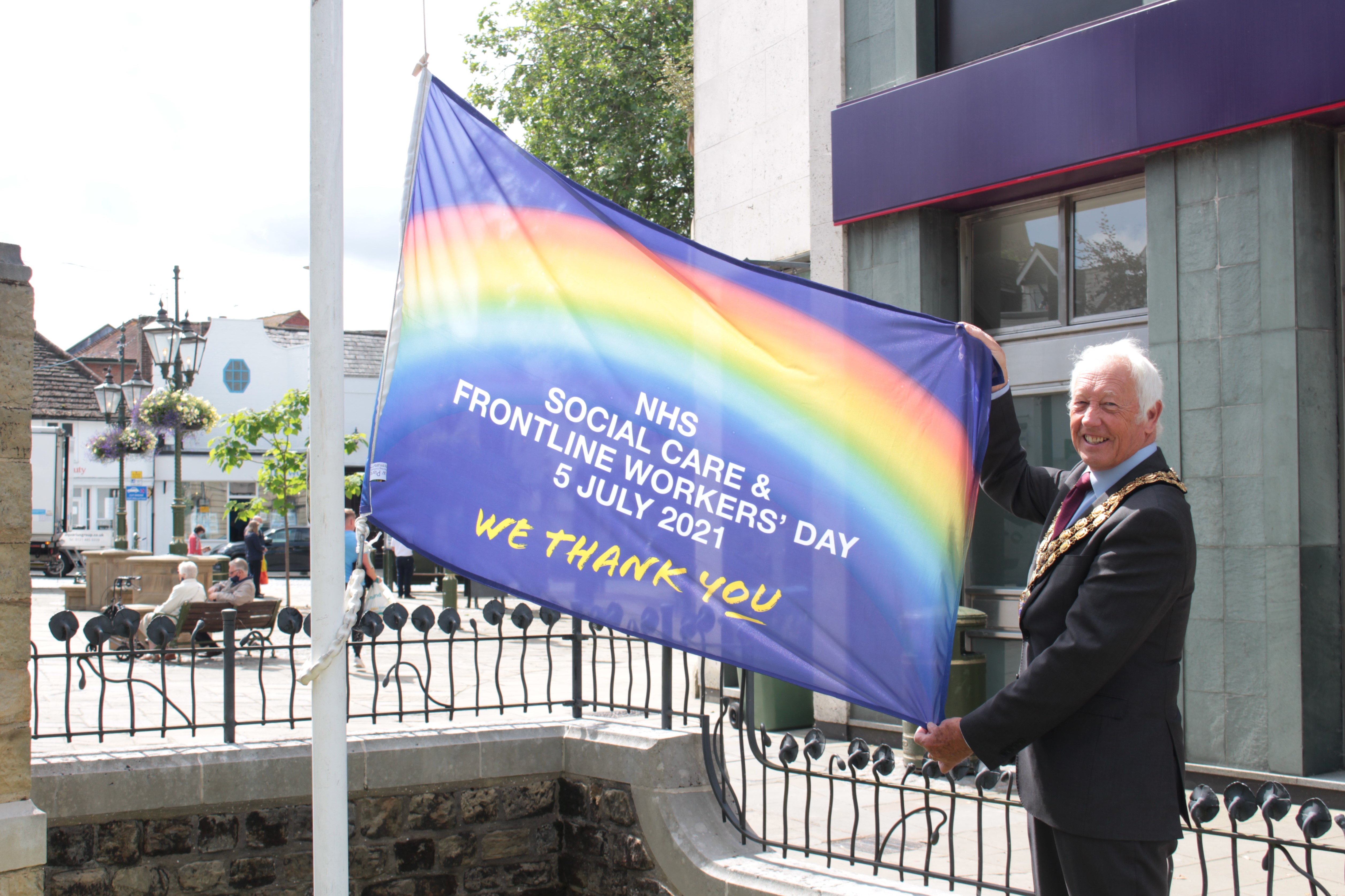 HDC Chairman David Skipp raises an NHS flag in Horsham's Carfax