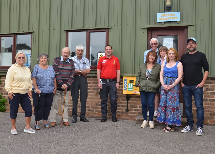 Roundstone residents, the site manager and Cllr Claire Vickers gather at the new defibrillator