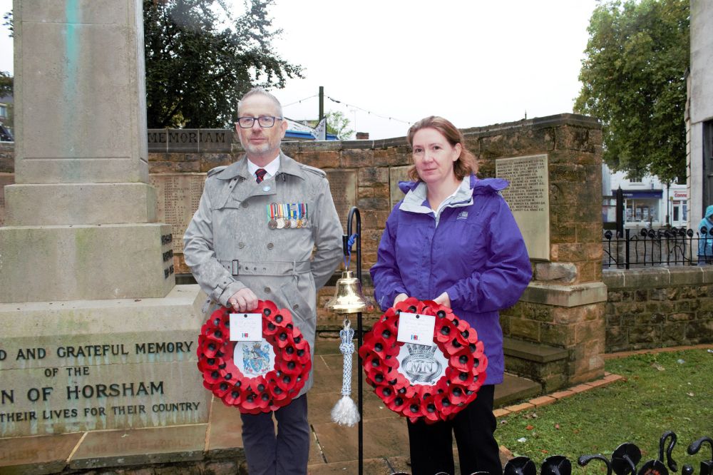 Horsham District Council Armed Forces Champi-on Cllr Clive Trott and Royal British Legion's Vice Chairman Carol Tester with the Merchant Navy bell at the War Me-morial